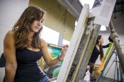 Students painting in art studio